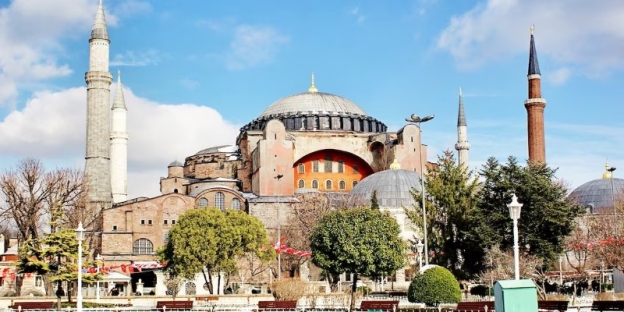 A large building with a dome with Hagia Sophia in the background AI-generated content may be incorrect.