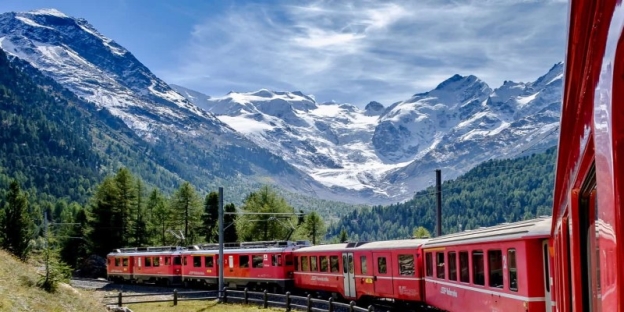 A train going through the mountains AI-generated content may be incorrect.