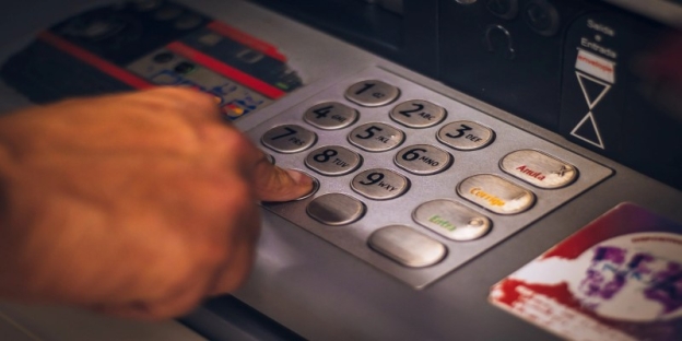 A person using a pin pad AI-generated content may be incorrect.