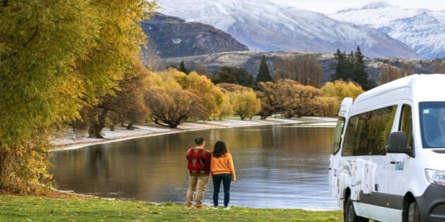 A couple of people standing by a lake AI-generated content may be incorrect.