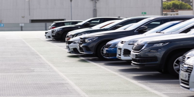 A row of cars in a parking lot AI-generated content may be incorrect.