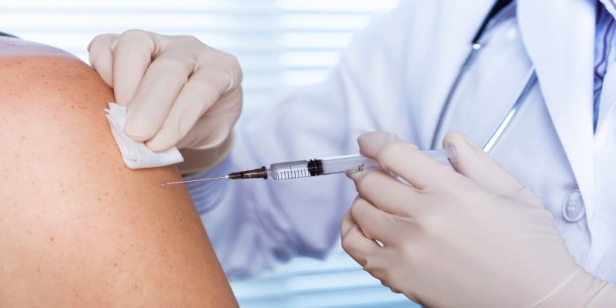 A close-up of a doctor giving a shot AI-generated content may be incorrect.