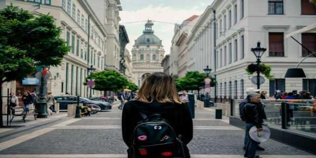 A person sitting on a bench in a city AI-generated content may be incorrect.